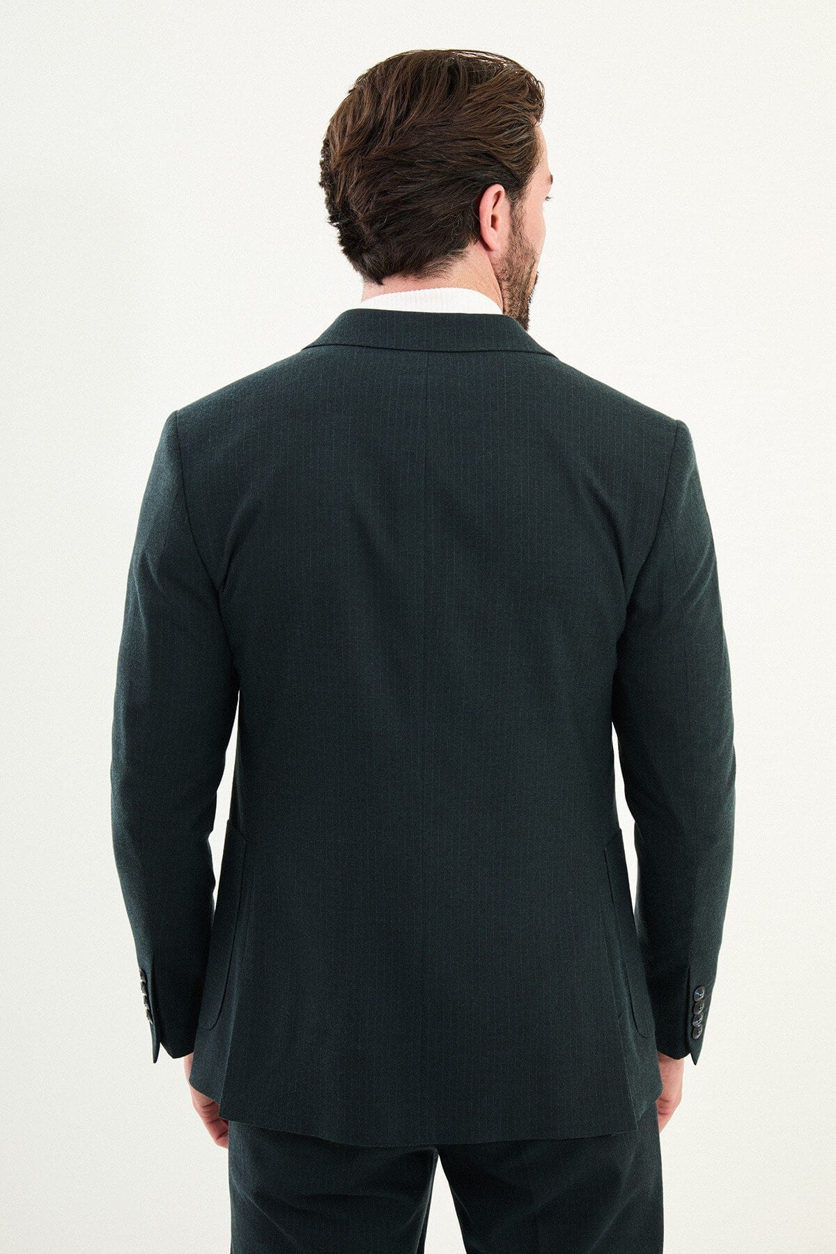 Men’s dark green slim-fit mono-collar (mandarin collar) suit with single-breasted jacket, matte micro-texture fabric, and clean minimalist tailoring designed for turtleneck layering.