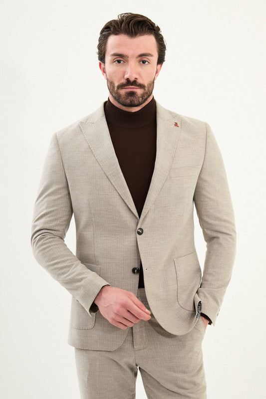 Men’s beige slim-fit mono-collar (mandarin collar) winter suit with minimalist single-breasted jacket, matte micro-texture active-recovery fabric, styled with a dark brown turtleneck.