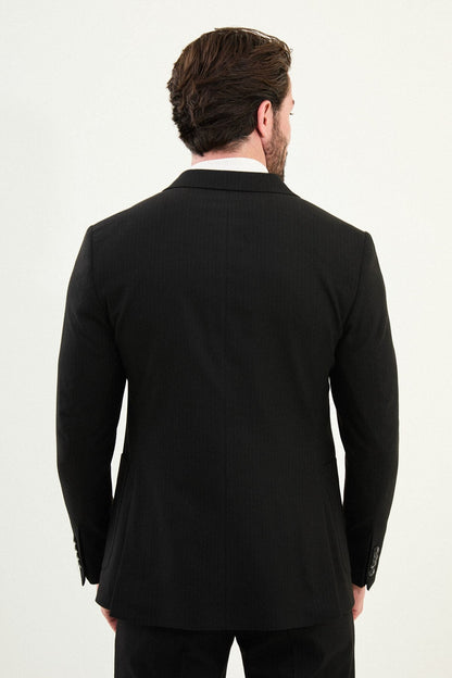 Men’s black mono-collar slim-fit suit with band/mandarin neckline, matte finish tailoring, single-breasted jacket styled with a white turtleneck, travel-ready stretch wool-viscose blend.