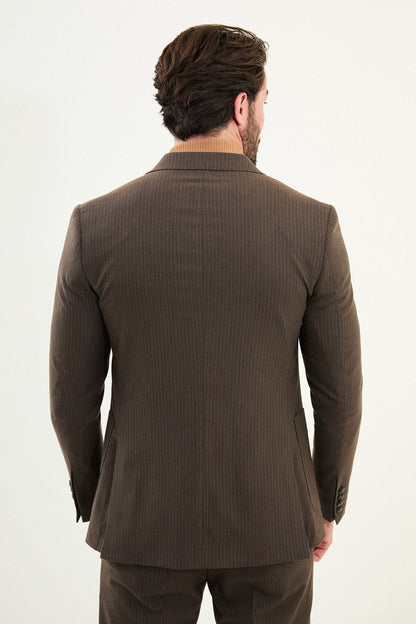 Men’s light brown slim-fit mono-collar (mandarin collar) winter suit with minimalist single-breasted jacket, matte micro-texture active-recovery fabric, styled with a camel turtleneck for tonal dressing.