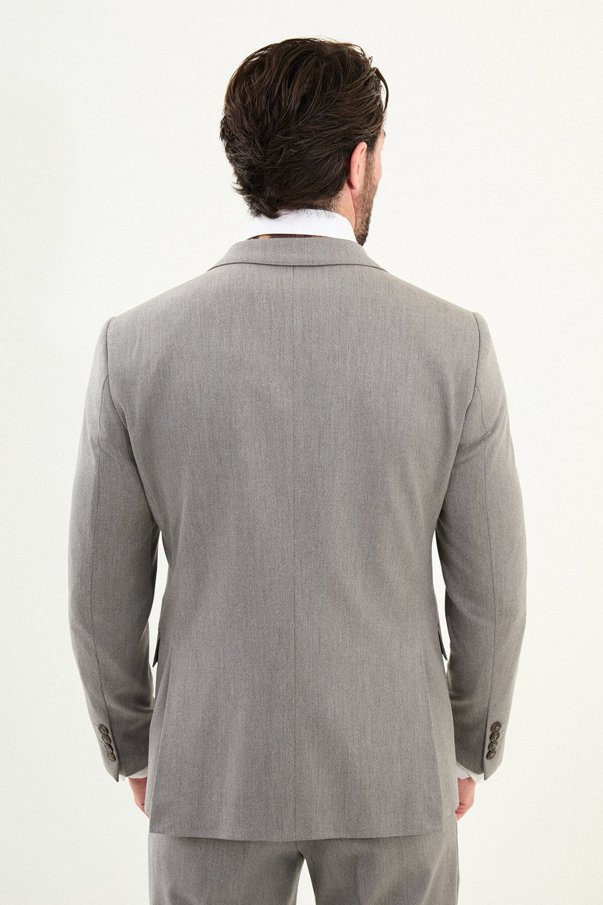 Men’s light gray slim-fit three-piece wool-blend winter suit with single-breasted jacket, notch lapels, matching waistcoat, dark buttons, and black origami lapel pin.